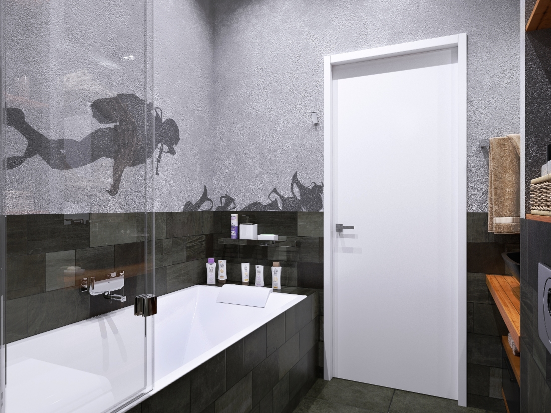 Серые стены с наклейкой в ванной комнате Оригинальное решение оформления стены в ванной комнате. Верхняя часть светло серая  а нижняя выложена темной плиткой. На верхней части наклейка в виде аквалангиста - стильно и неординарно.